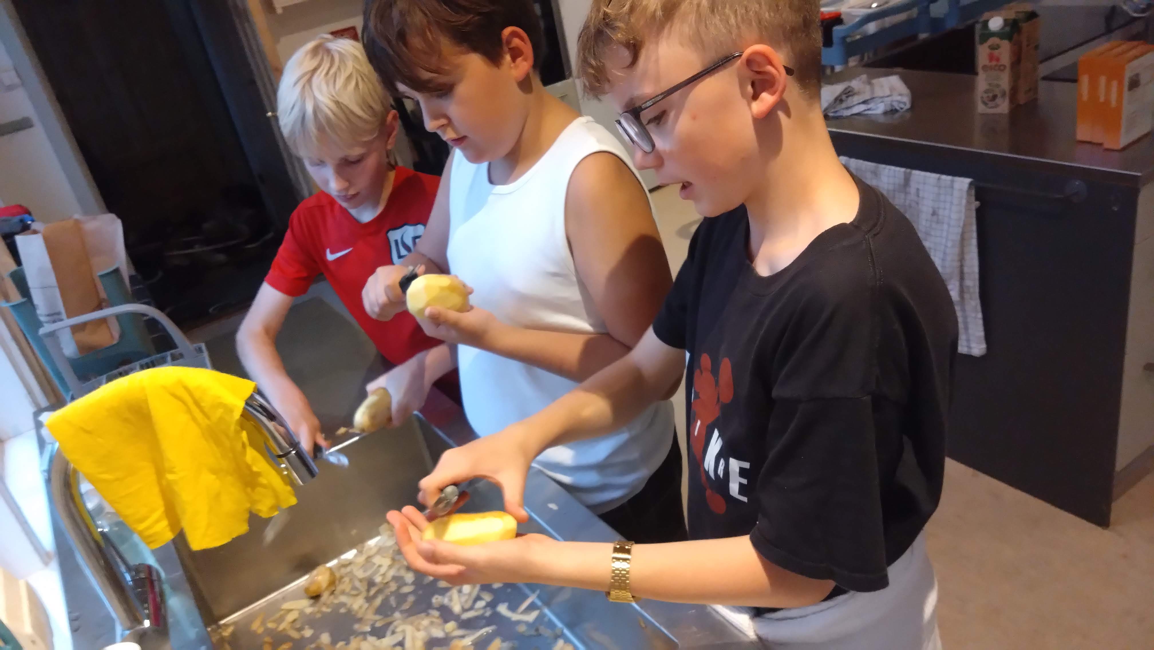 Børn som skæller kartofler